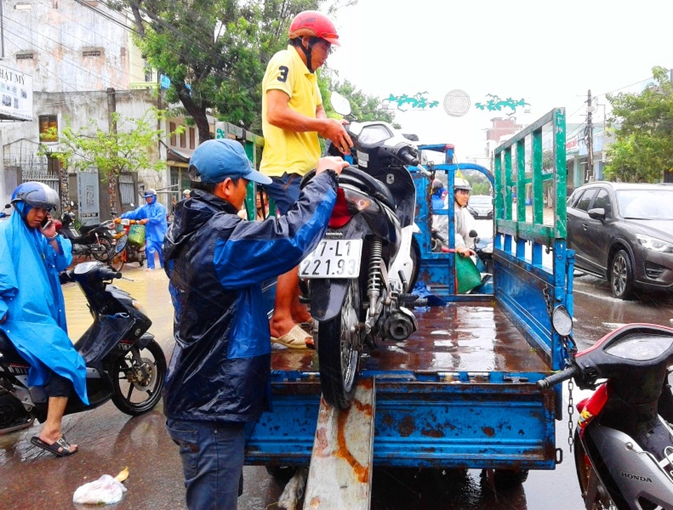 “Hốt bạc” nhờ vận chuyển xe và người vượt lũ… - 6 Tại nút giao thông đường Hùng Vương (TP Quy Nhơn), người dân phải mất 40.000 đồng/người/xe/lượt để vượt qua đoạn đường ngập lụt chỉ khoảng 1 km (ảnh chụp trưa ngày 3/11)