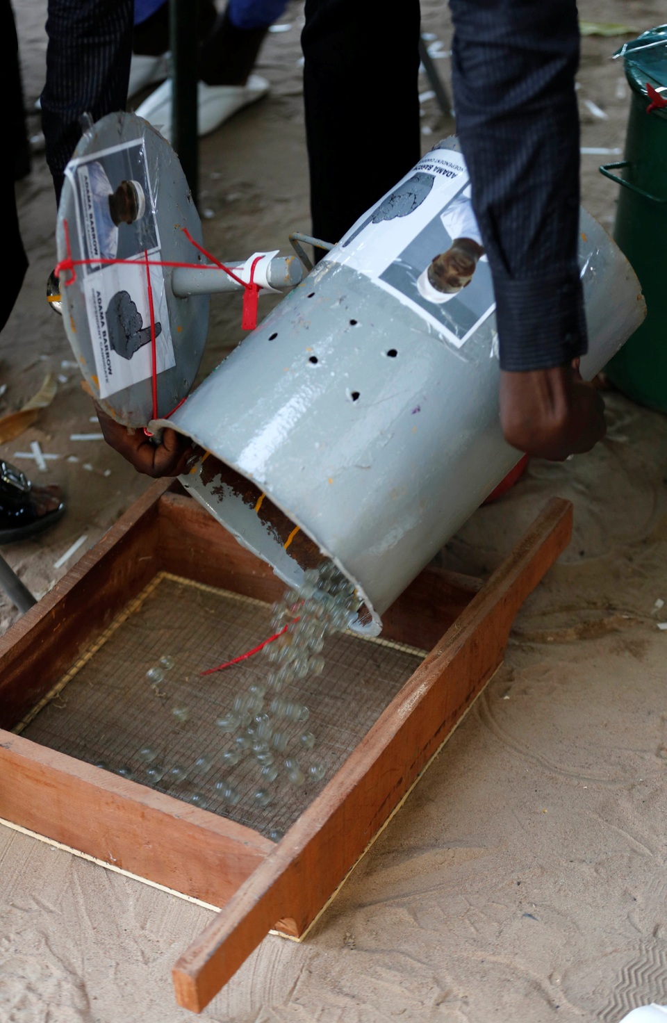 Sau khi các cử tri bỏ phiếu xong, toàn bộ số bi trong các thùng sẽ được đổ ra những chiếc khay đặc biệt, có từ 200-500 lỗ, giúp các nhân viên phụ trách bầu cử có thể đếm chính xác và nhanh chóng số bi dành cho mỗi ứng viên tổng thống (Ảnh: Reuters)