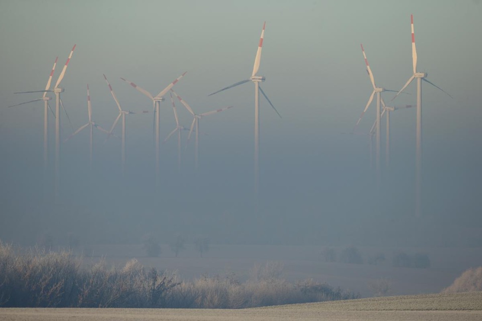 Những tua-bin chạy bằng sức gió vươn lên khỏi lớp sương mù dày đặc trong buổi sáng sớm ở đô thị Irxleben, Đức.