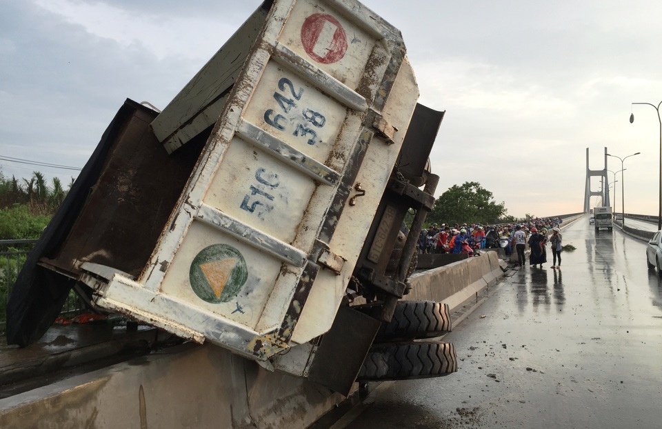 Chiếc xe ben 15 tấn chạy với tốc độ nhanh rồi lật nhào ngay dốc cầu Phú Mỹ, phía quận 2, TPHCM.