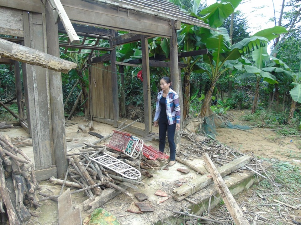 Chị Xuân bên căn nhà tan hoang sau trận lũ