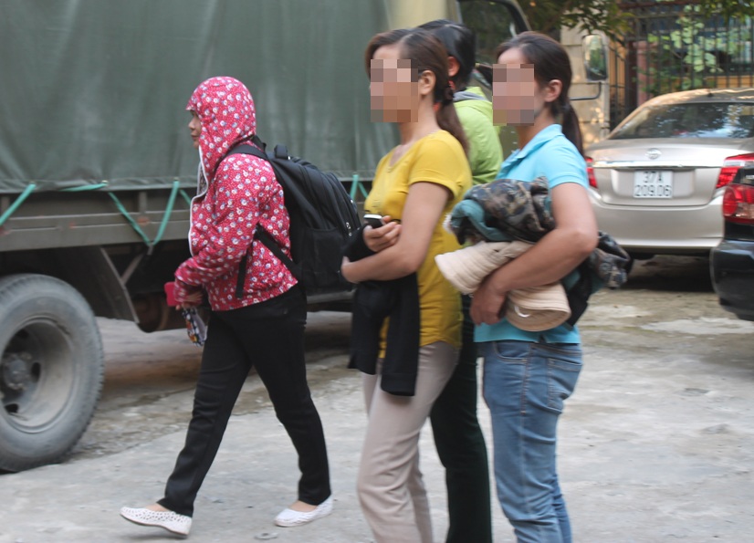 Hai người vợ của Dương (áo đỏ và áo xanh) đến tham dự phiên tòa xét xử chồng.