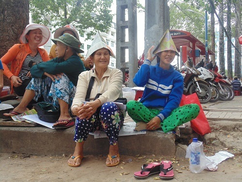Phụ huynh chờ con thi, mỏi tay nhận tờ rơi - 4 Nhiều phụ huynh tận dụng