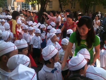 Cô giáo rất vất vả để cŨỉnh đội ngũ cho học sinh lớp 1.