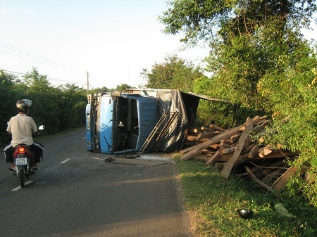 Nhiều khối gỗ trên xe đổ lăn lóc ra lề đường