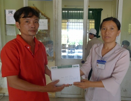 Đại diện bạn đọc Dân trí bà Lê Thị Dung trao số tiền