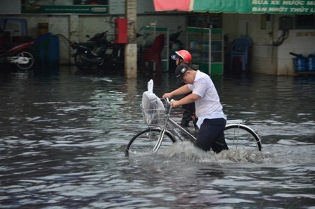 Học sinh nam cũng không thể đạp xe trong điều kiện đường ngập sâu như thế này