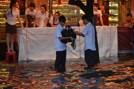 Đến tối, nhiều học sinh vẫn đang loay hoay trong dòng nước đen ngòm để về nhà
