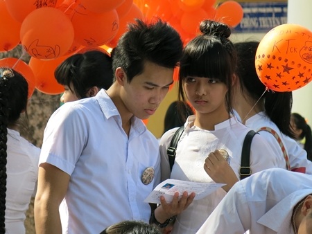 Cầm trên tay tờ giấy báo dự thi,...