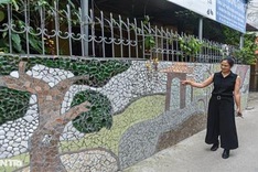 Villagers create ceramic wall from thrown-away items