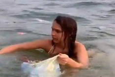 Russian woman collects litter on Phu Quoc beach