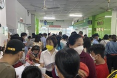 People queue for fourth Covid-19 jab in HCM City