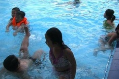 Parents rush to bring children to swimming practice classes