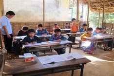 Mixed aged pupils share classroom in mountainous area
