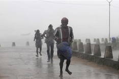Cyclone in India kills 8 as typhoon hits Japan