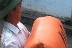 University graduates carry rice, retail goods to bide their time