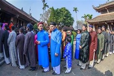 Artists, ambassadors bringing back áo dài for men