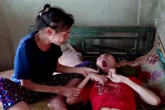 Ailing poor woman takes care of cerebral palsy son