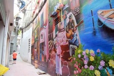 Houses in Hanoi alley decorated with mural