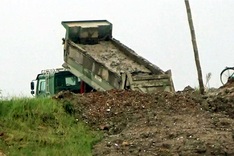 Trucks dumping potentially toxic mud into Red River