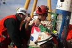 14 Chilean miners emerge in problem-free rescue