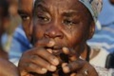 One month after quake, Haitians join to mourn dead