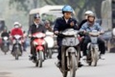 Bikers risk texting on Vietnam's roads
