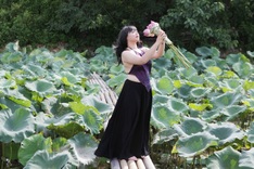 Young Hanoi women enchanted by lotus blossoms