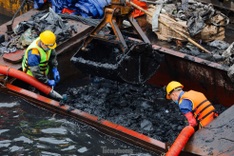 Hanoi ​workers ​wade ​through ​polluted ​waters to ​dredge ​To L​ich River