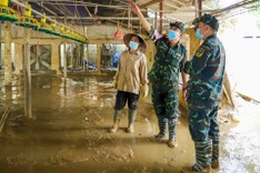 Military forces help to spray disinfectant in flood-hit areas