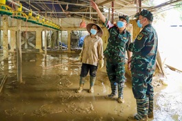 Military forces help to spray disinfectant in flood-hit areas